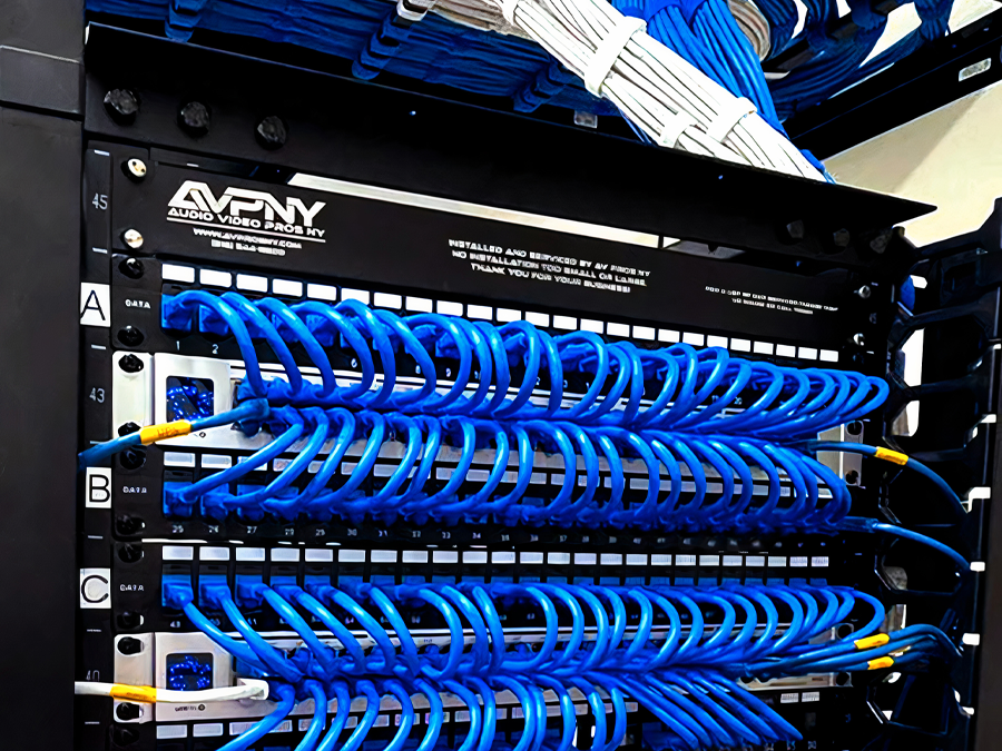 Organized network cabling and patch panels in an AV Pros NY equipment rack